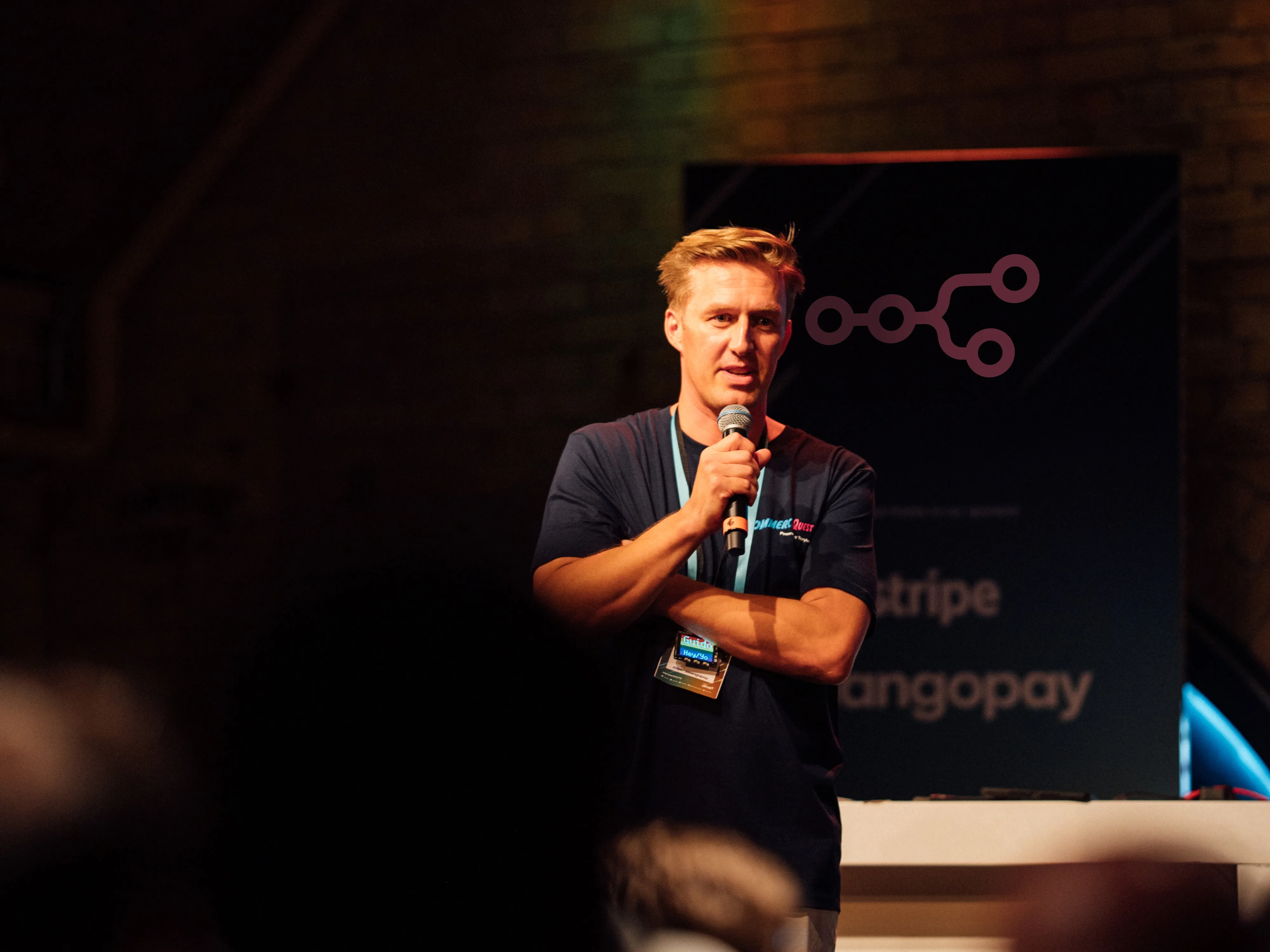 Guido Jansen speaking on stage at a technology conference