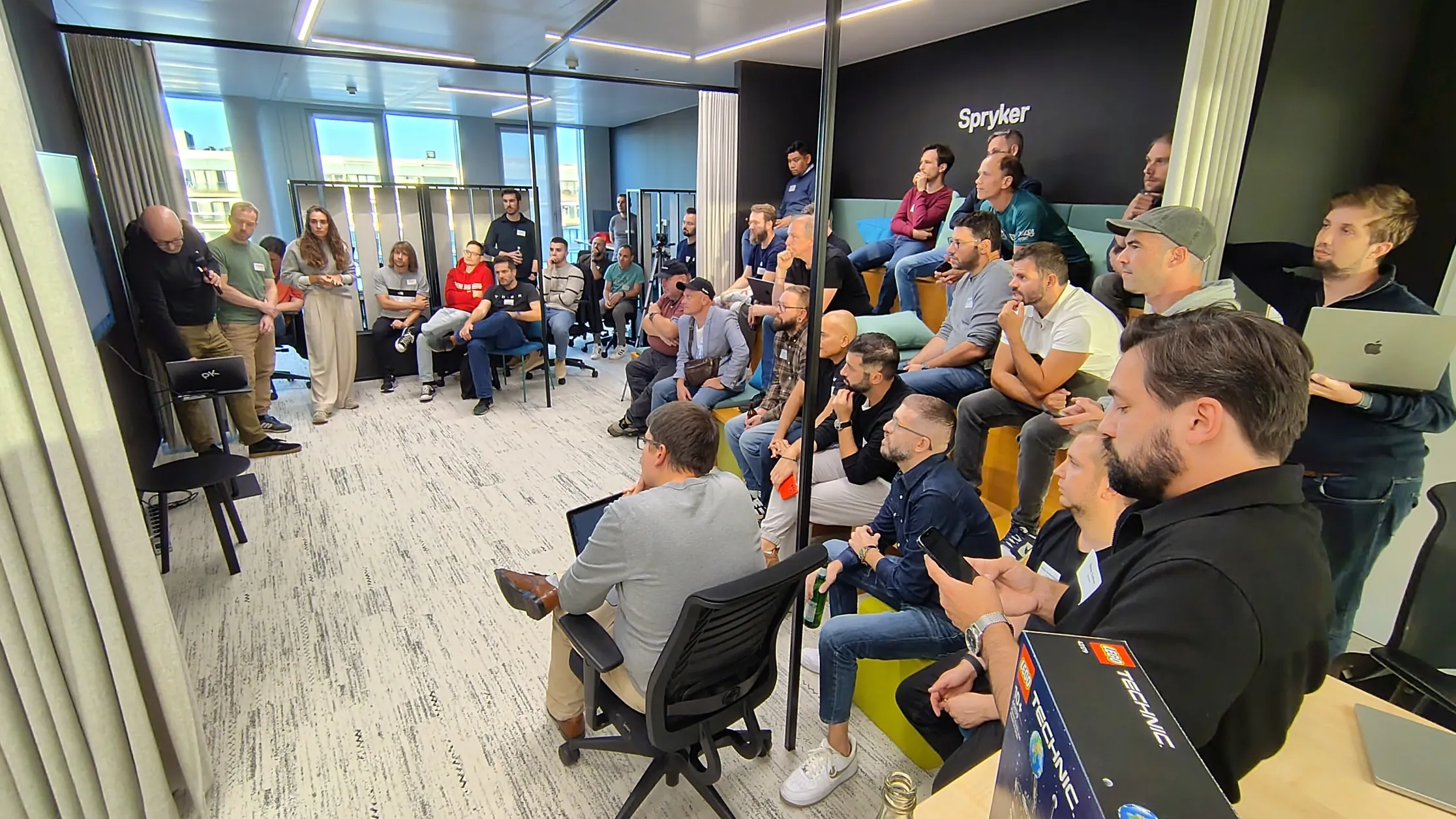 Hackathon team presentations at the Berlin office, September 2025, with multiple members from the Spryker Product and Tech teams on-site.